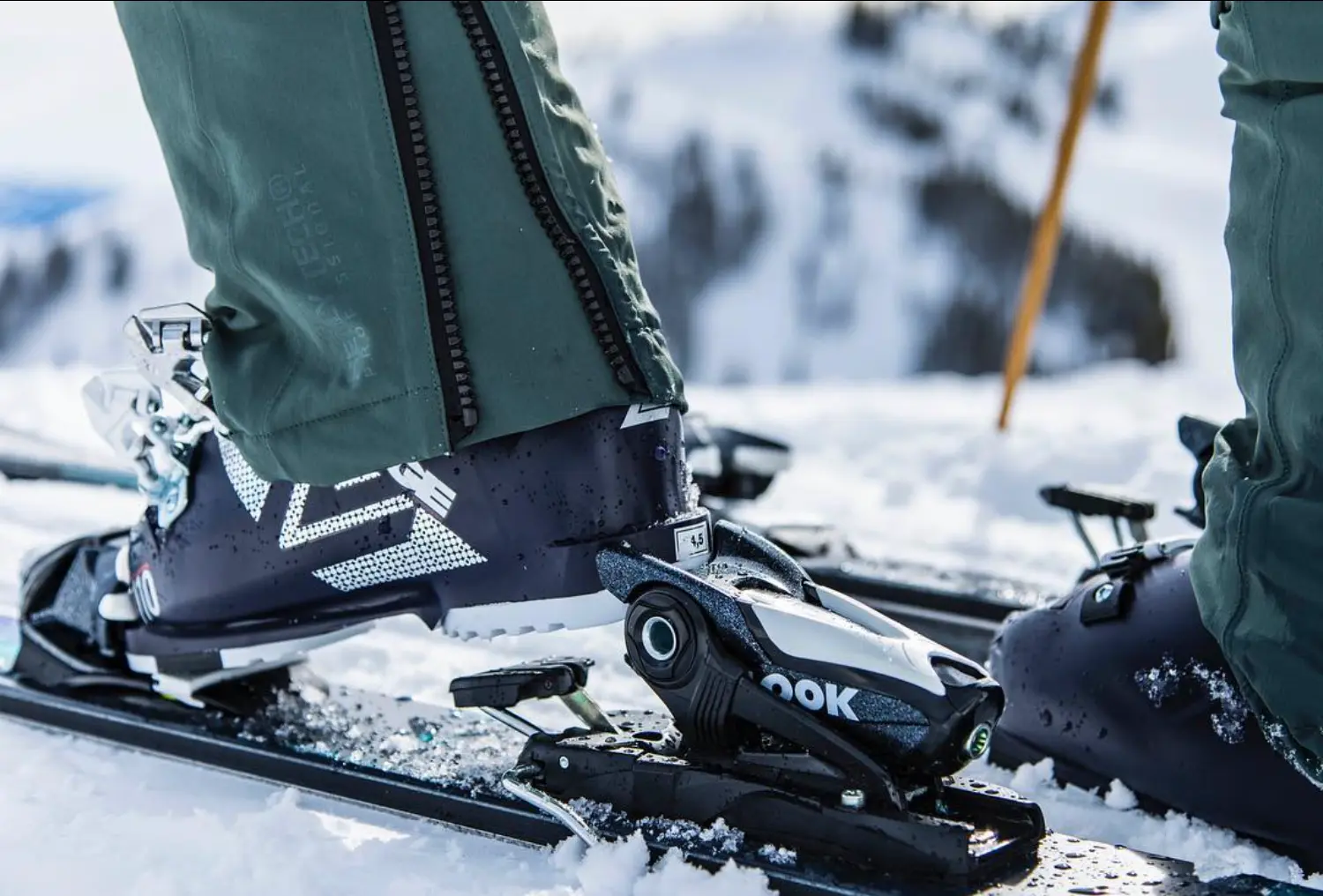 Close up view of a ski boot and ski, the person is lifting their foot from the ski binding.